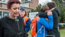 People embrace outside the Brussels airport.