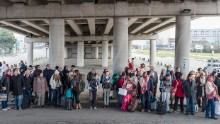 Evacuated passengers gather outside the airport.