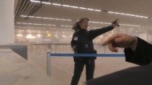 A police officer directs passengers in a smoke-filled terminal at the Brussels airport.