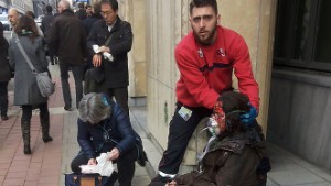 A private security guard helps a wounded women outside the Maalbeek metro station in Brussels on March 21, 2016 after a blast at this station located near the EU institutions.
Belgian firefighters said at least 26 people had died after "enormous" blasts rocked Brussels airport and a city metro station today, as Belgium raised its terror threat to the maximum level. / AFP / Michael VILLA        (Photo credit should read MICHAEL VILLA/AFP/Getty Images)