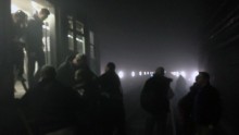 Metro passengers leave their carriages and walk along the tracks following an attack on the Brussels underground transport system.
