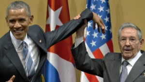 Cuban President Raul Castro, right,  tries to lift up the arm of President Barack Obama at the conclusion of their joint news conference at the Palace of the Revolution, Monday, March 21, 2016, in Havana, Cuba. (AP Photo/Ramon Espinosa)