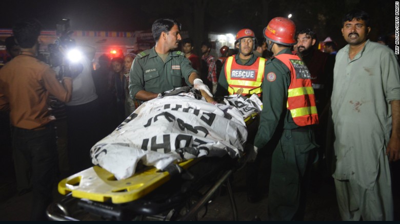 Pakistani rescuers use a stretcher to shift a body from a bomb blast site in Lahore on March 27, 2016. At least 25 people were killed and dozens injured when an explosion ripped through the parking lot of a crowded park where many minority Christians had gone to celebrate Easter Sunday in the Pakistani city Lahore, officials said. / AFP / ARIF ALI (Photo credit should read ARIF ALI/AFP/Getty Images)