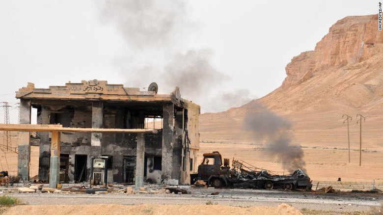 Smoke rises near a gas station as a result of fighting between Syrian government forces and ISIS militants in Palmyra, Syria, on Sunday, March 27, 2016. Syrian forces recaptured Palmyra from ISIS on Sunday, months after the city fell to the Islamic extremist group, state media reported.