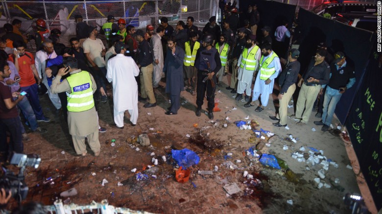 Rescuers and officials gather at the site of the blast. 