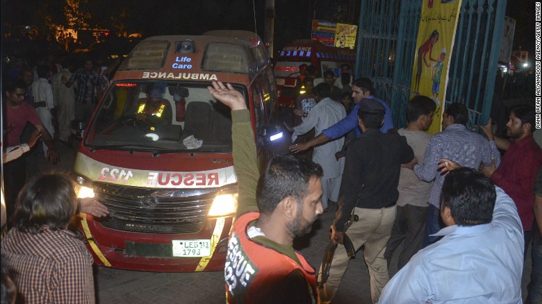 Rescue workers and police gather near the site where a suicide bomber blew himself up in a crowded park in Lahore, Pakistan, on Sunday, March 27. The blast killed at least 60 people and injured 200, according to health adviser for Punjab province Khawaja Salman Rafique.