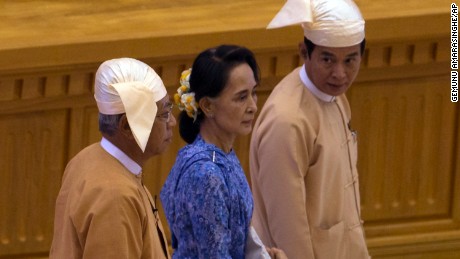 Htin Kyaw, left, walks with Aung San Suu Kyi at his swearing in ceremony.