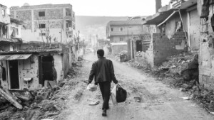 A man walks in the ruins of his city, Cizre. The city suffered a lot during the 78 days of curfew. The clashes between the turkish government and PKK rebels were very violent and left many homes in ruins. Cizre, Turkey, March 2016. 