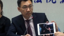 Taiwanese legislator Johnny Chiang shows a video image from the Kenyan jail cell.