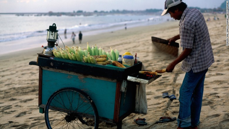 Jimbaran Beach sits on Bali&#39;s southwestern coast, where the mainland connects to the Bukit Peninsula. It&#39;s home to luxury resorts like the Four Seasons and the Intercontinental. Restaurants line the shore with tables on the sand.