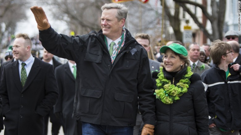 Massachusetts Gov. Charlie Baker marches with his wife, Lauren, in Boston&#39;s St. Patrick&#39;s Day Parade.
