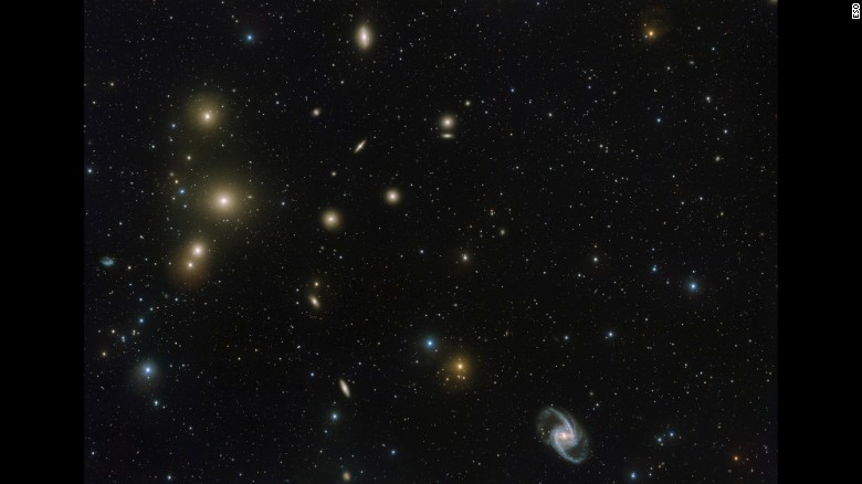 This image from the VLT Survey Telescope at ESO&#39;s Paranal Observatory in Chile shows a stunning concentration of galaxies known as the Fornax Cluster, which can be found in the Southern Hemisphere. At the center of this cluster, in the middle of the three bright blobs on the left side of the image, lies a cD galaxy -- a galactic cannibal that has grown in size by consuming smaller galaxies.