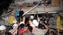 Rescue workers work to pull out survivors trapped in a collapsed building after a huge earthquake struck, in the city of Manta early on April 17, 2016. 
At least 41 people were killed when a powerful 7.8-magnitude earthquake struck Ecuador, destroying buildings and sending terrified residents dashing from their homes, authorities said late on April 16.
 / AFP / API / ARIEL OCHOA        (Photo credit should read ARIEL OCHOA/AFP/Getty Images)