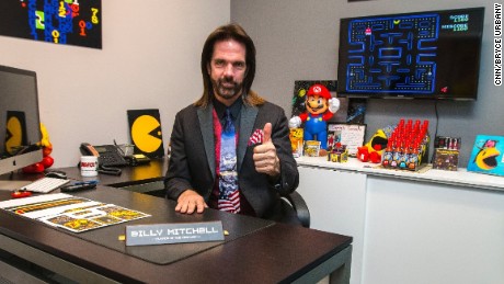 Billy Mitchell sits in his office at Metro Wrapz, in Hollywood, Florida, where he is developing custom arcade game covers.