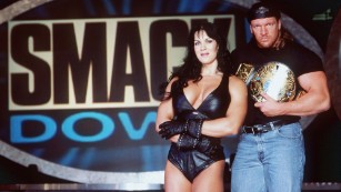 Chyna and wrestler Triple H pose for a photo in 1999.