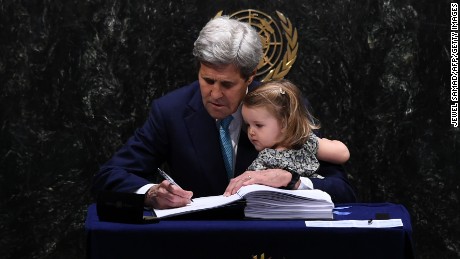 Secretary of State John Kerry signs the Paris Agreement with granddaughter Isabelle Dobbs-Higginson.