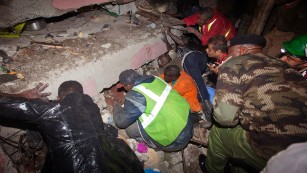 Rescue personnel work at the site of the collapse.