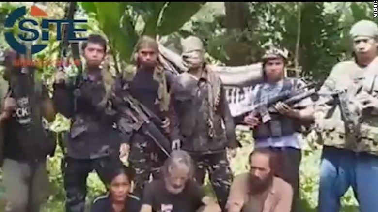 A screengrab from a video obtained by extremist monitoring organization SITE purportedly shows three hostages held by Abu Sayyaf.