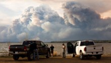 Evacuees watch the wildfire near Fort McMurray on May 4.