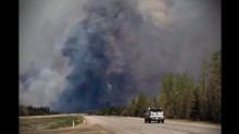 A truck drives toward a wildfire in Fort McMurray, Alberta, on May 6. 