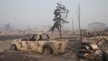 Home foundations and shells of vehicles are nearly all that remain in a residential neighborhood in Fort McMurray, Alberta, on May 6. 