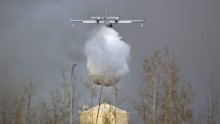 A water bomber drops water over Fort McMurray, Alberta, on May 6, 2016. 
