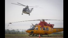 A helicopter helping with the Fort McMurray wildfire takes off from a staging base near Conklin, Alberta, on May 7.
