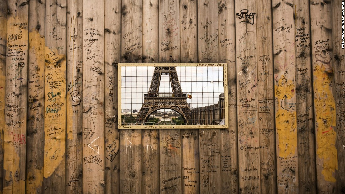 The Eiffel Tower is seen through a grille in wooden panels surrounding a construction site. The iconic tourist attraction finished in 14th place in TripAdvisor's 2016 list of the world's <a href=