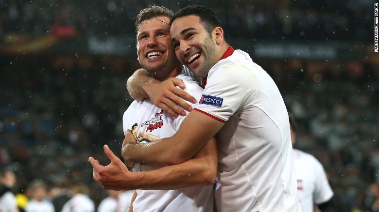 Sevilla&#39;s Kevin Gameiro, left, and Adil Rami celebrate their 3-1 victory over Liverpool in the Europa League final, which was played Wednesday, May 18, in Basel, Switzerland.  The Spanish club has now won the tournament for the third consecutive season.