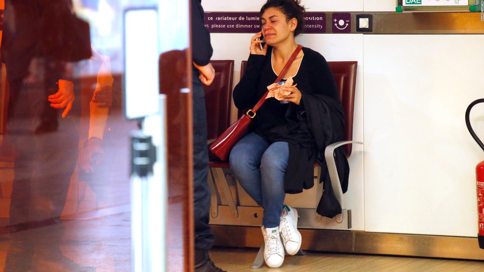 A relative of the victims of the EgyptAir flight 804 that crashed, reacts as she makes a phone call at Charles de Gaulle Airport outside of Paris, Thursday, May 19, 2016. Egyptian aviation officials say an EgyptAir flight from Paris to Cairo with 66 passengers and crew on board has crashed. (AP Photo/Michel Euler)