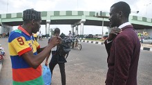 "I just saw this man wearing a bowtie and suit and cleaning a windscreen" says photographer David Sync who decided to approach Olatoyan.