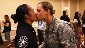 DENVER, CO - May 13: Denver Sheriff's deputy graduate Victoria Fermin-Weinreb, left, gets a kiss from her wife U.S. Army Sgt. Kathryn Fermin-Weinreb during the Denver Sheriff's department's Academy Class graduation at the Renaissance Hotel May 13, 2016. This year's graduating class represents the largest group of recruits in the department's history with 80 graduates. (Photo by Andy Cross/The Denver Post via Getty Images)