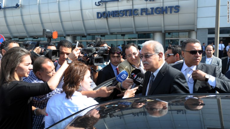 Egyptian Prime Minister Sherif Ismail talks to reporters at Cairo International Airport.