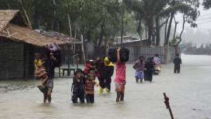 Bangladeshi villagers make their way to shelter.