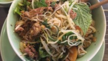 In this broth-free bowl of vermicelli noodles, tender slices of beef mingle with crunchy peanuts, bean sprouts, fresh herbs, crisp dried shallots, a splash of fish sauce and fiery chili pepper.