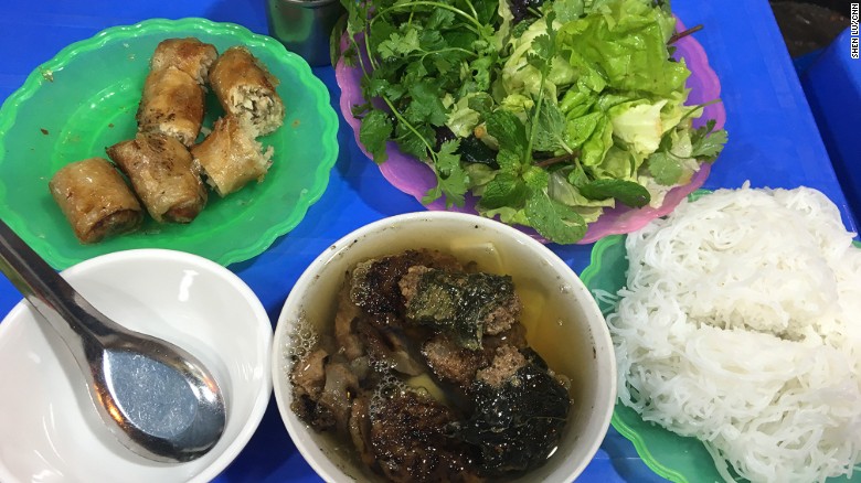 In this dish, small patties of seasoned pork and slices of marinated pork belly are grilled over a charcoal fire. The charred, crispy morsels are served with a large bowl of a fish sauce-heavy broth, a basket of herbs and a helping of rice noodles.