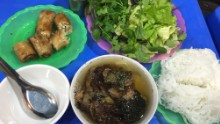 In this dish, small patties of seasoned pork and slices of marinated pork belly are grilled over a charcoal fire. The charred, crispy morsels are served with a large bowl of a fish sauce-heavy broth, a basket of herbs and a helping of rice noodles.
