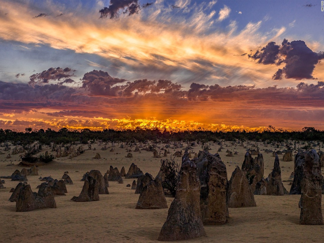 Sam Yick captures a moment of fiery light over the stark landscape of the Pinnacles rock formations in Western Australia. (<a href="http://travel.nationalgeographic.com/photographer-of-the-year-2016/" target="_blank">Click here to enter NatGeo photo contest</a>)