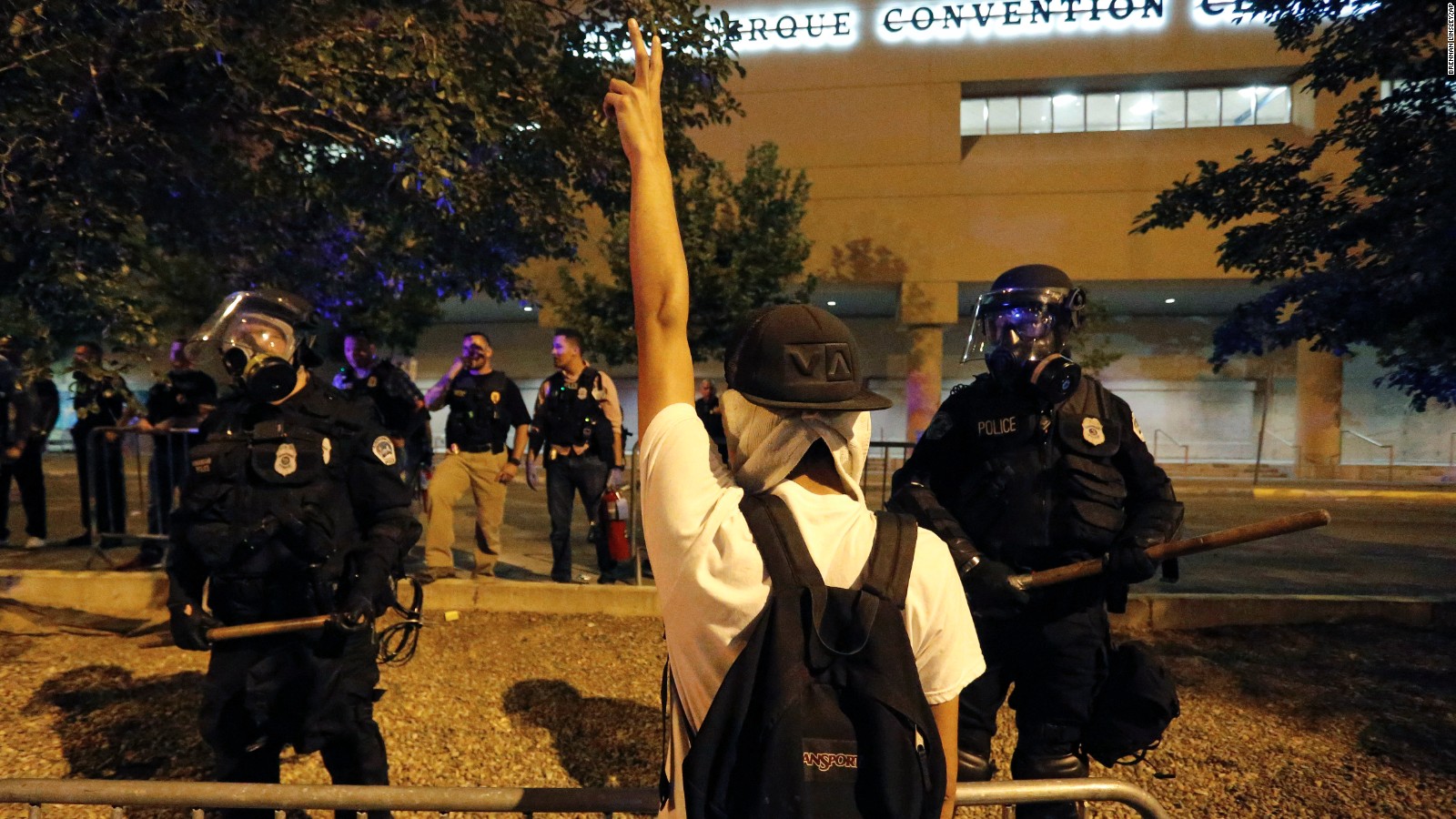 Riot police block off the Albuquerque Convention Center to anti-Trump protests following a rally and speech by Republican presidential candidate Donald Trump at the convention center where the event was held, in Albuquerque, N.M., Tuesday, May 24, 2016. (AP Photo/Brennan Linsley)
