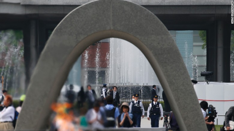 Police officers, seen through the cenotaph, patrol at Hiroshima Peace Memorial Park in Hiroshima.