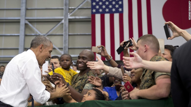 President Obama greets military personnel at the Marine Corps Air Station Iwakuni.
