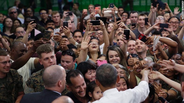 U.S. President Barack Obama, foreground center, is greeted by U.S. Marines and their families at Iwakuni air station.