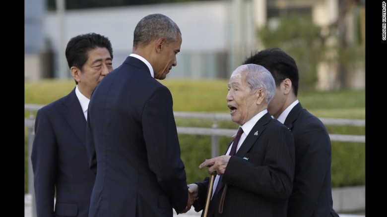 President Obama, center, accompanied by Japanese Prime Minister Shinzo Abe, left, shakes hands and talks with Sunao Tsuboi, a survivor of the 1945 atomic bombing and chairman of the Hiroshima Prefectural Confederation of A-bomb Sufferers Organization (HPCASO), at Hiroshima Peace Memorial Park in Hiroshima, western Japan.