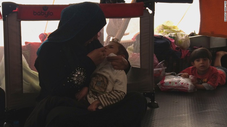 Johaina Daar talks tenderly to her son Alyaman while feeding him with a syringe.