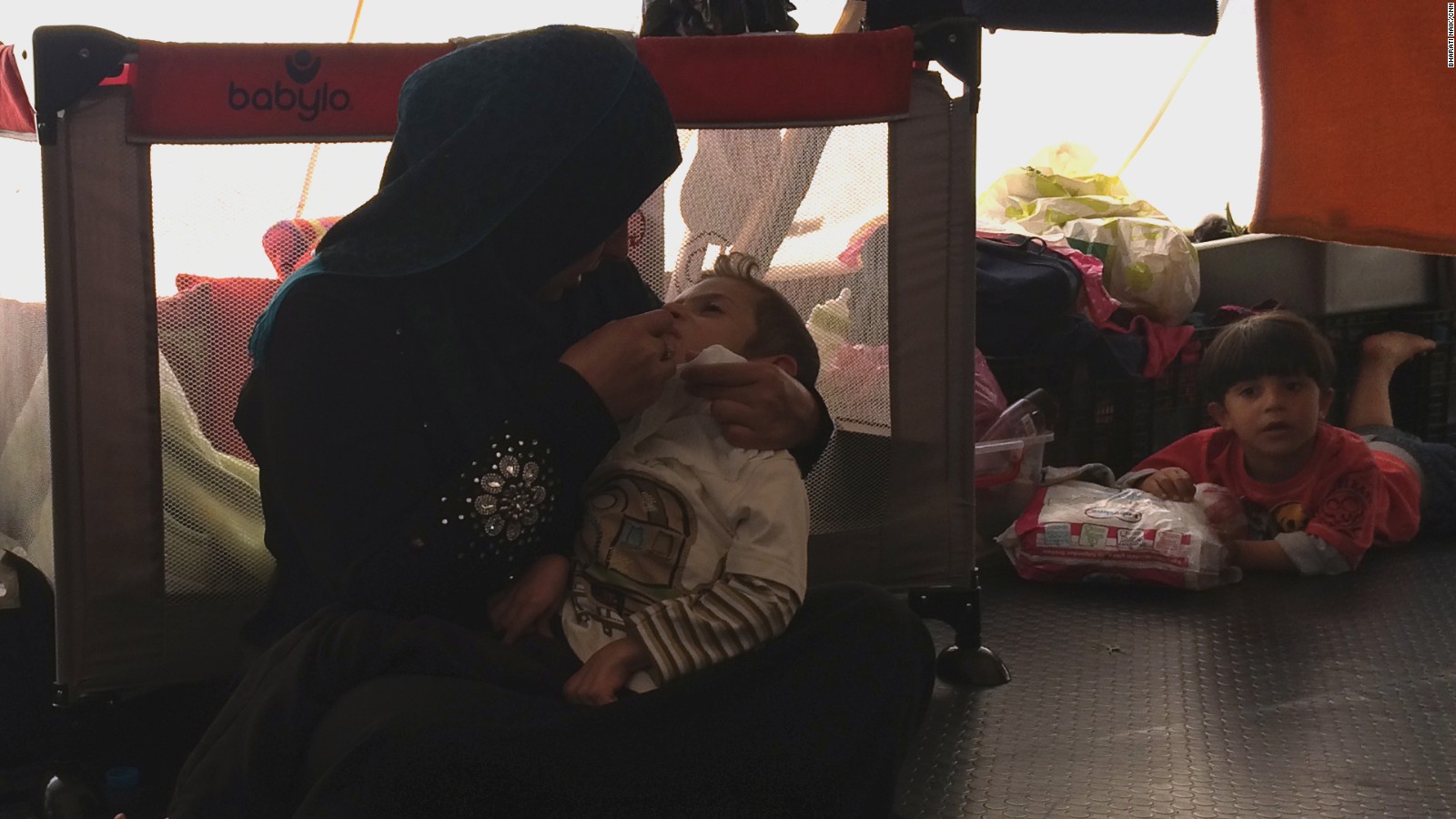 Johaina Daar talks tenderly to her son Alyaman while feeding him with a syringe.