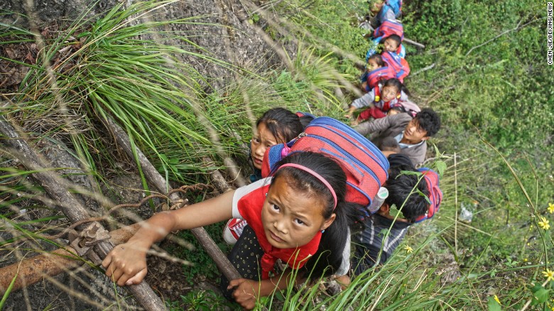 Fifteen children ages 6 to 15 go to school at the foot of a mountain. They make the journey climbing the unsteady &quot;sky ladders,&quot; as locals call them.