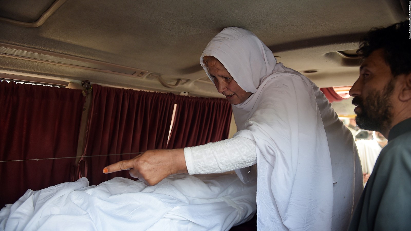 Maria's grandmother mourns next to her body in an ambulance outside a hospital in Islamabad.