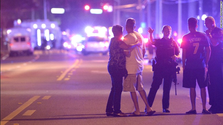Police in Orlando direct family members away from the scene of the shooting early on June 12.