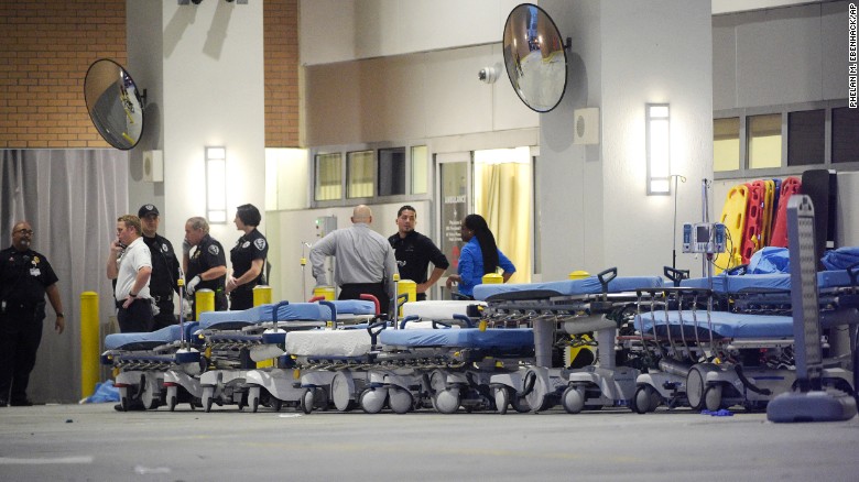 Medical personnel wait with stretchers at the Orlando Regional Medical Center.