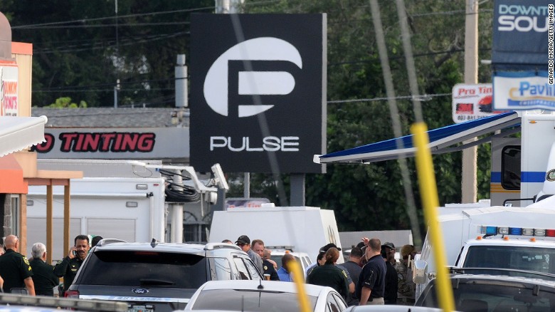 Police officers gather outside of the nightclub, which describes itself as &quot;the hottest gay bar&quot; in the heart of Orlando.